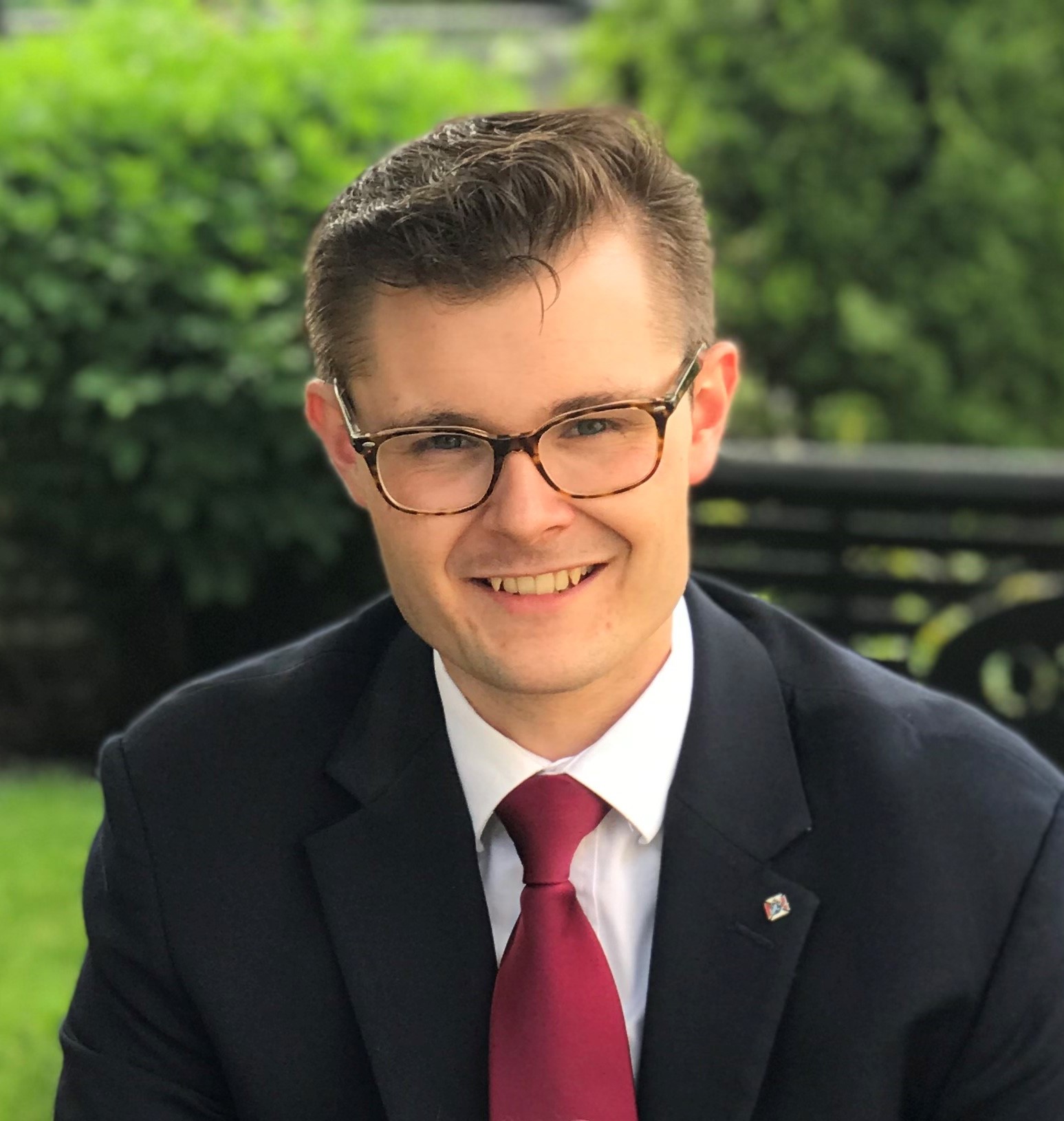 A professional headshot of Nicholas Holoman 